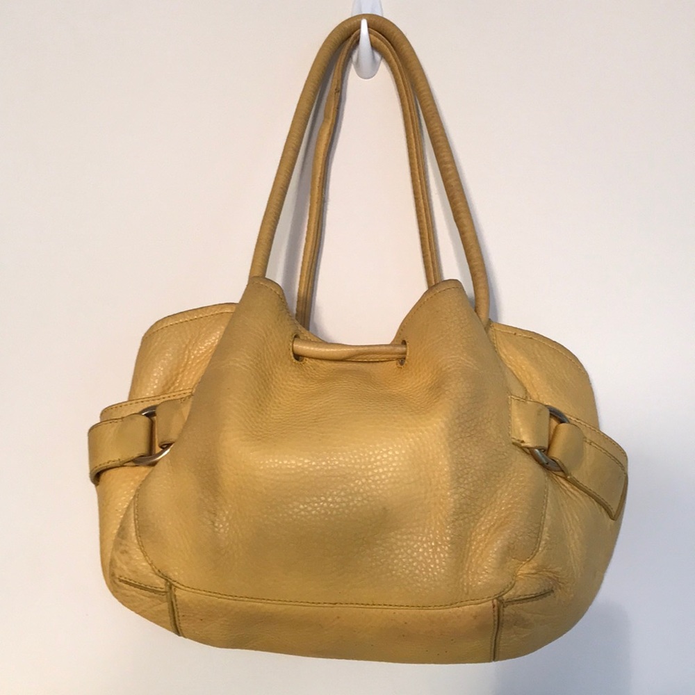 Cole Haan thick leather handbag. Magnetic closure, interior pockets, brass rings